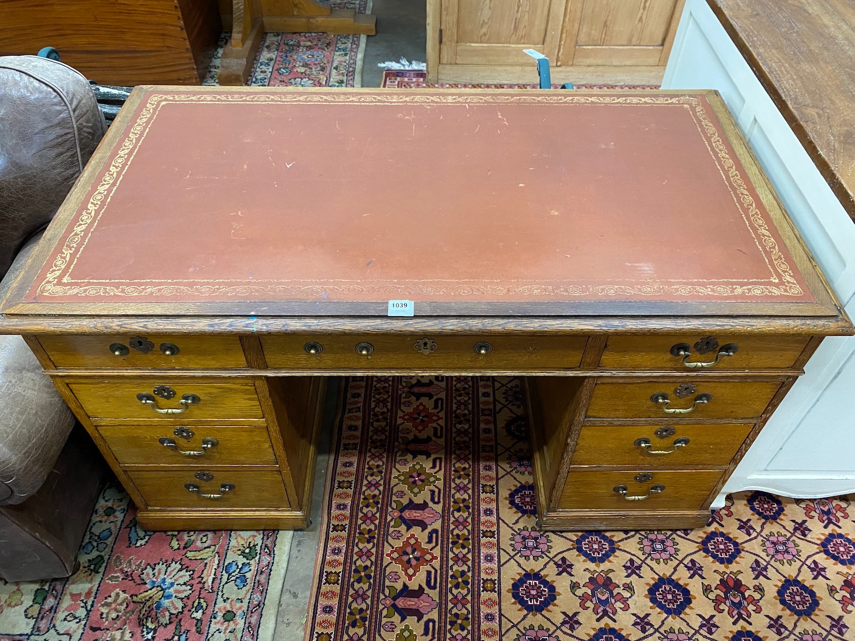 An Edwardian oak pedestal desk, width 138cm
